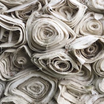 Rolls of white fabric stacked