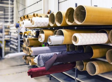 Rolls of fabric in a warehouse