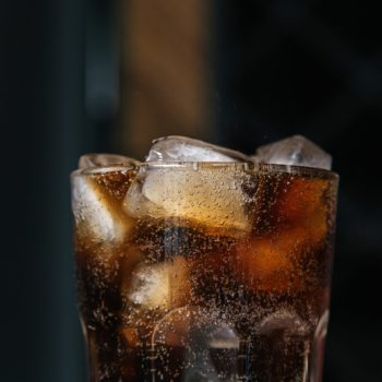 Glass of cola soft drink with ice cubes