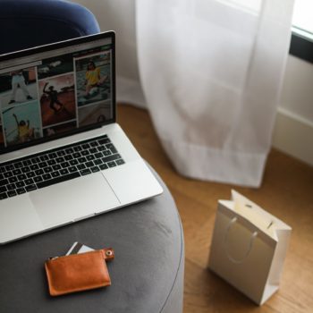 Laptop resting on a chair.