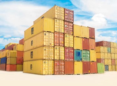 Pile of containers, used in the shipping industry, stacked on the dockside