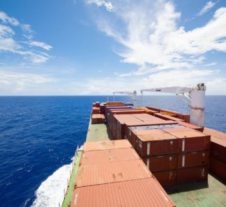 Shipping containers on a cargo ship at sea.