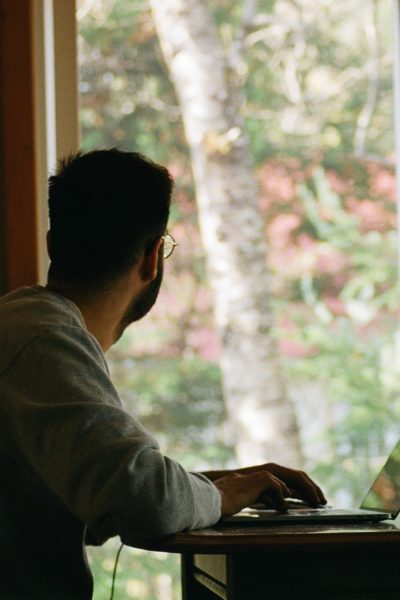 Man working from home looking out the window.