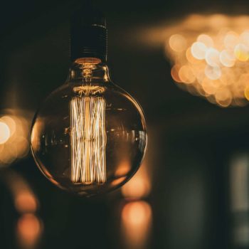 A large lightbulb with lights in the background