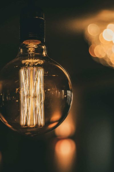 A large lightbulb with lights in the background