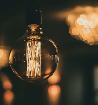A large lightbulb with lights in the background