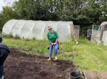 Katie volunteering and digging potatoes