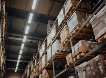 Warehouse shelves staked with boxes and wooden pallets