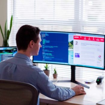 Man using computer with two screens