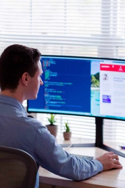 Man using computer with two screens